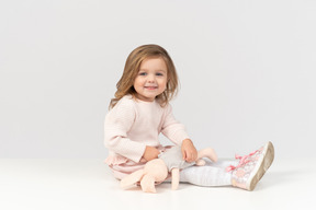 Cute little girl playing with a bunny toy