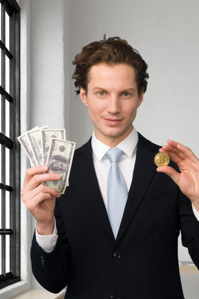 A man in a suit holding money and a coin
