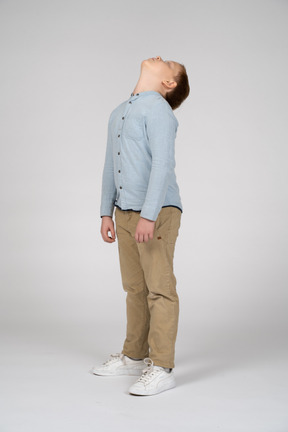 Boy in casual clothes looking up