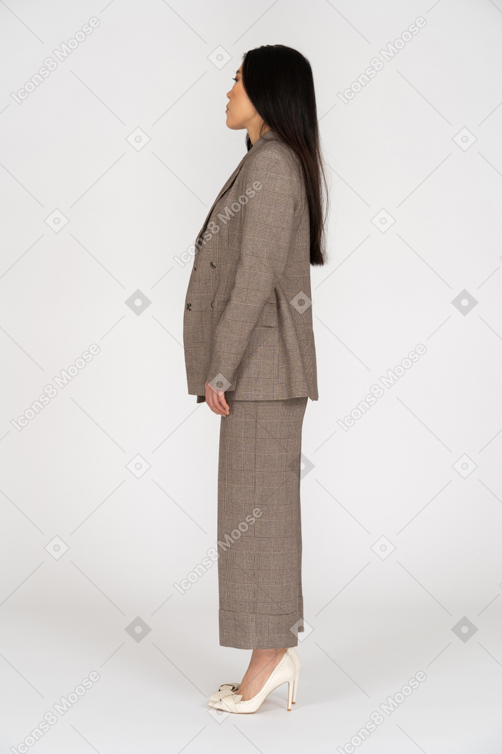 Вид сбоку молодой леди в коричневом деловом костюме