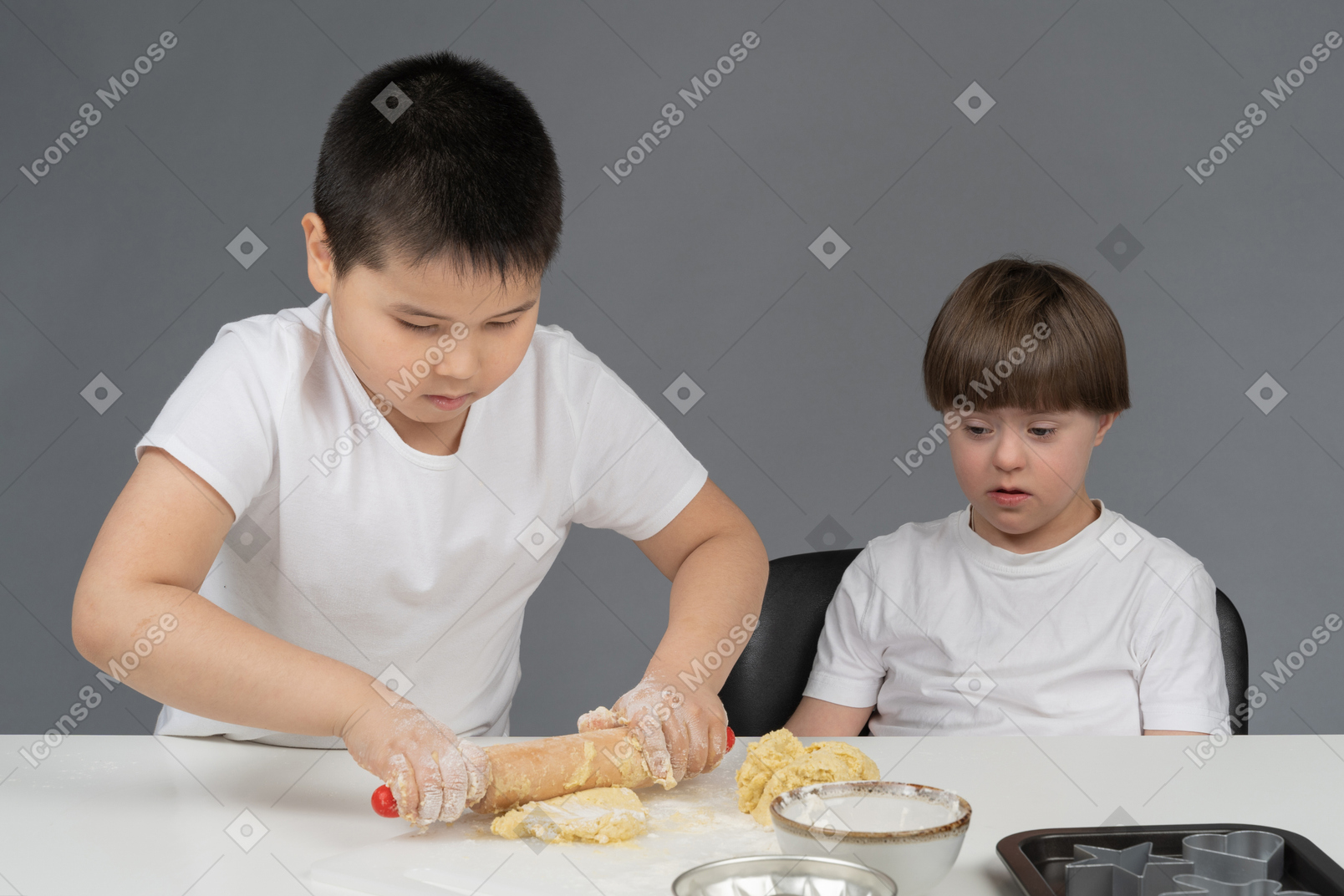 Two little boys practicing in baking