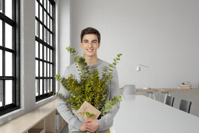 A man holding a bunch of plants in his hands