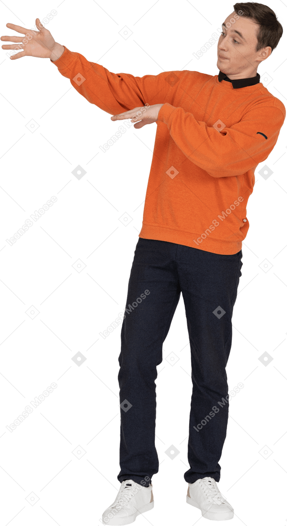 Young man in orange sweatshirt standing