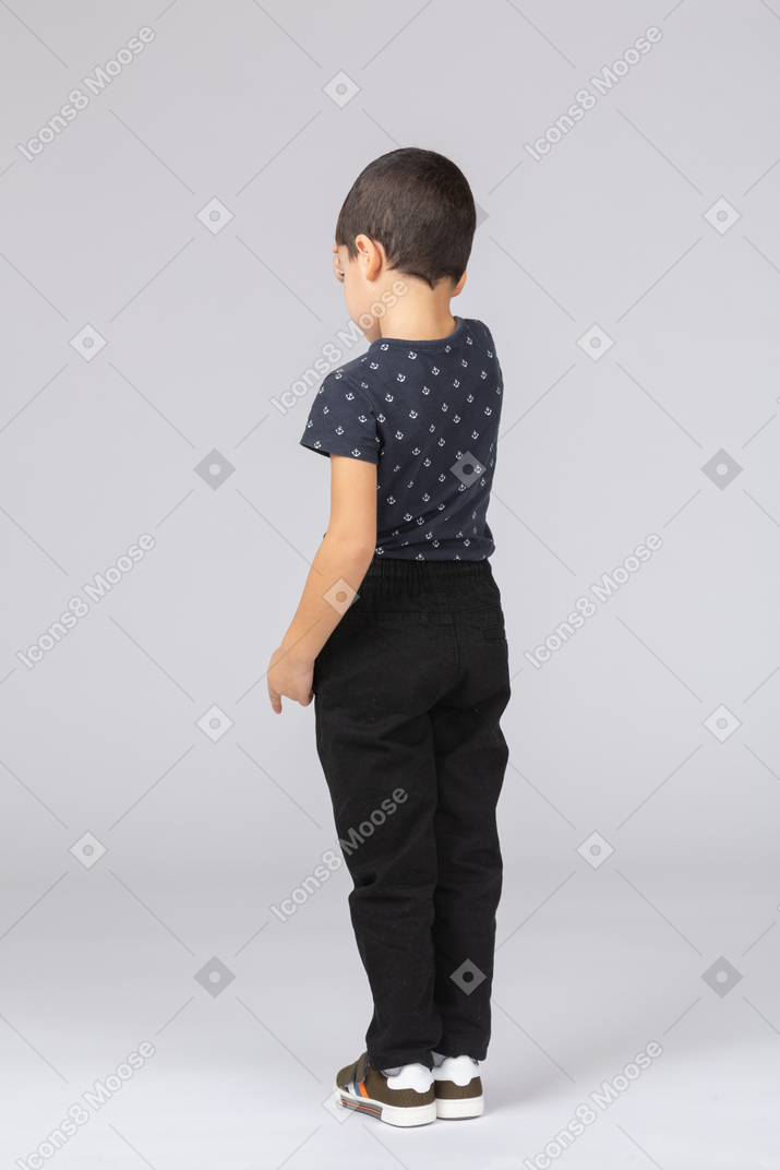 Rear view of a cute boy in casual clothes