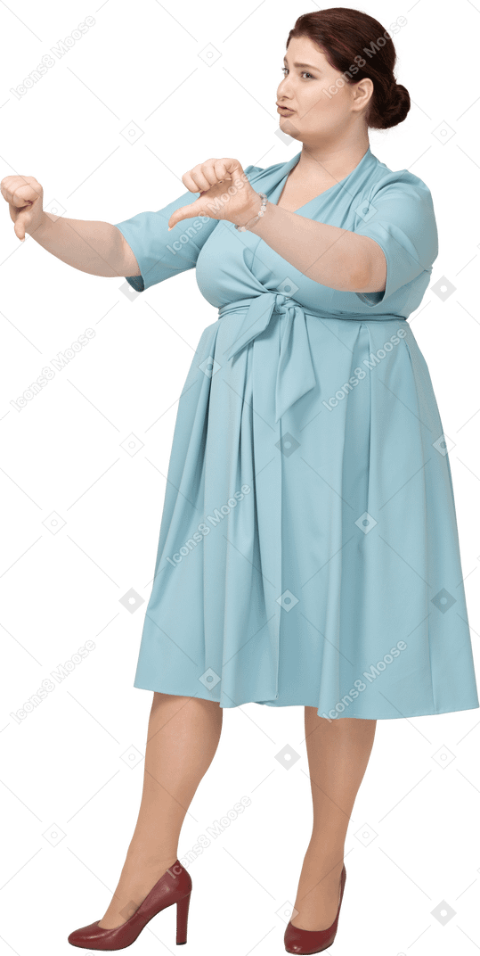 Front view of a woman in blue dress showing thumbs down