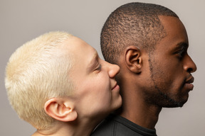 Young woman leaning on man's back