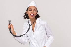 Attractive young female doctor holding a stethoscope