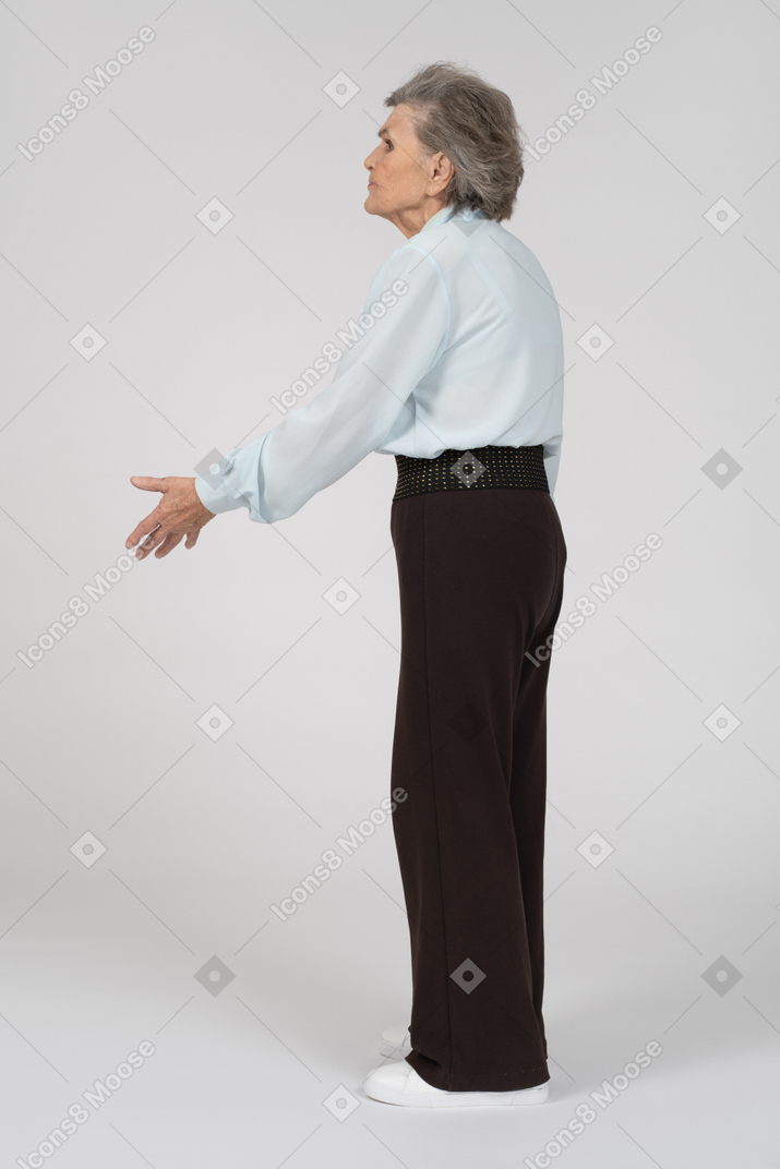 Side view of an old woman gesturing questioningly