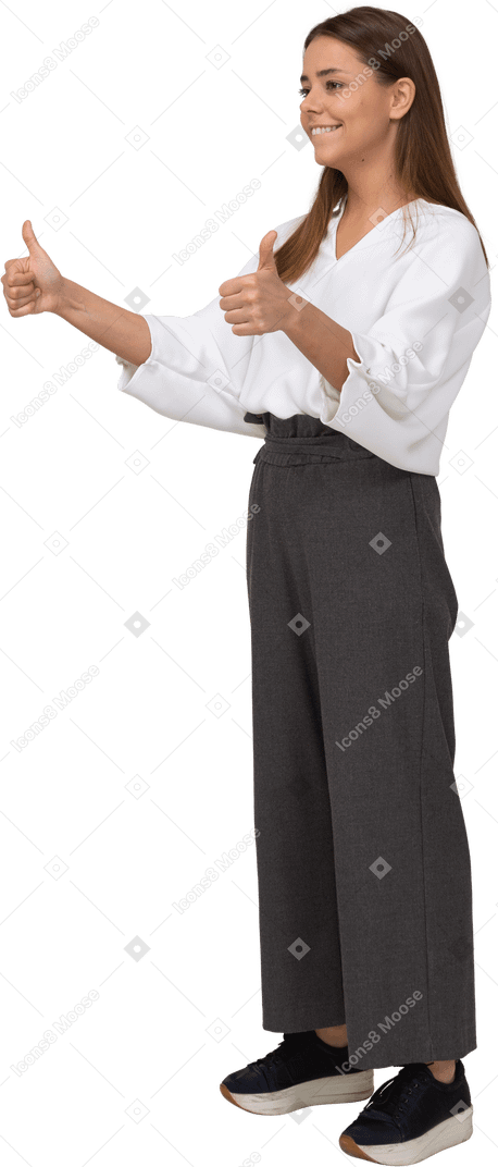 Three-quarter view of a young lady in office clothing showing thumbs up
