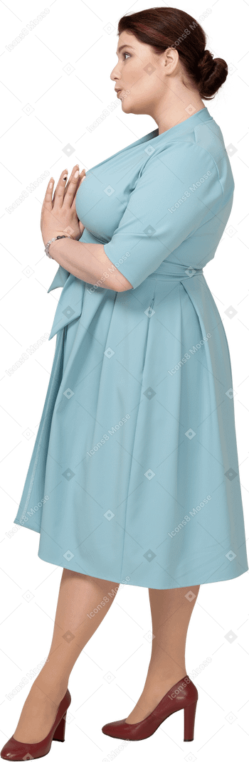 Side view of a woman in blue dress