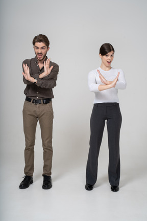 腕を組む事務服の若いカップルの正面図