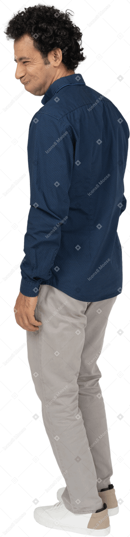 Side view of a man in casual clothes making faces