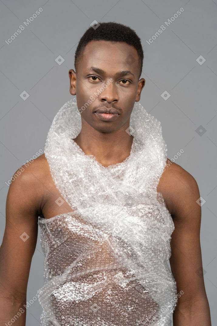 A portrait of a african man wrapped in plastic