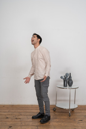 Side view of a man in casual clothes shouting