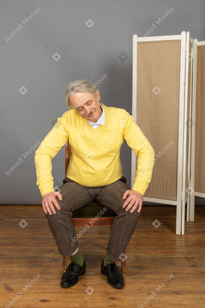 Middle-aged man sitting in chair with his eyes closed
