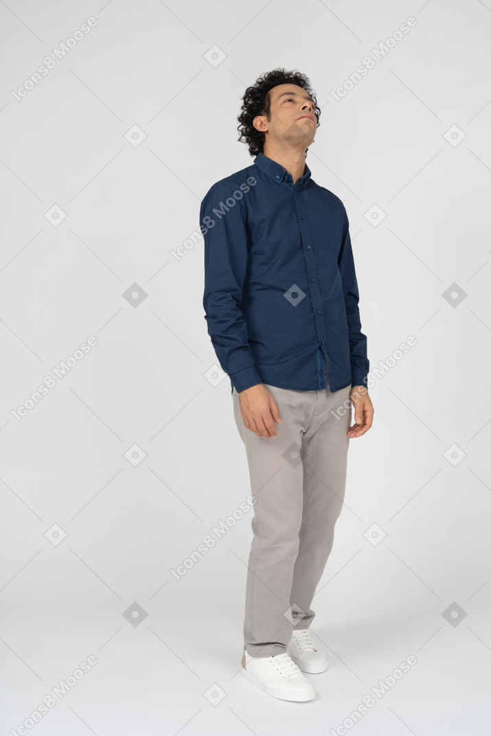 Front view of a man in casual clothes looking up