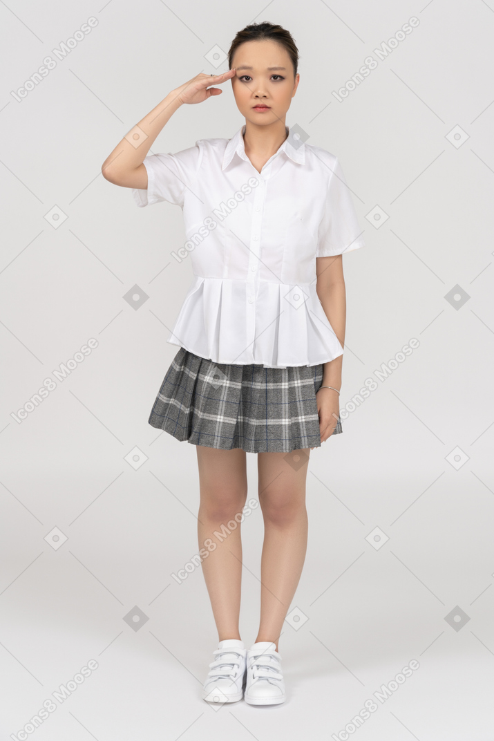 Serious asian girl giving a salute