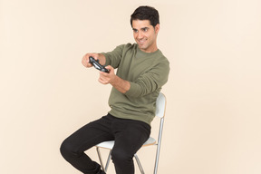 Young caucasian guy playing a videogame