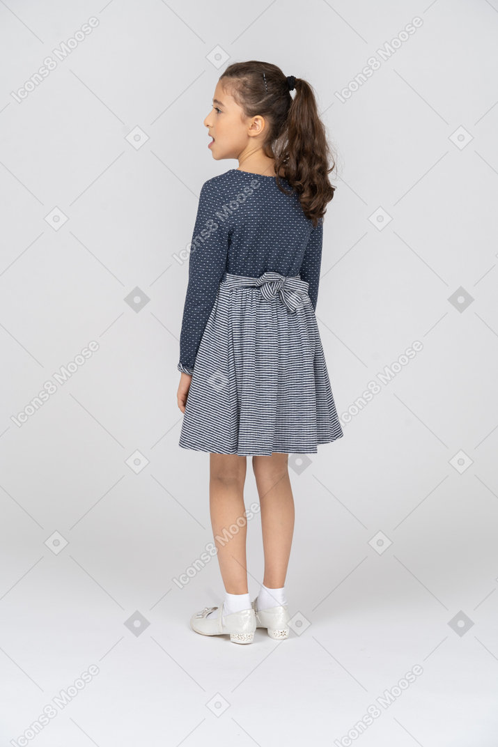 Three-quarter back view of a girl looking to the side