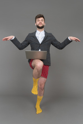 A young man balancing on one leg