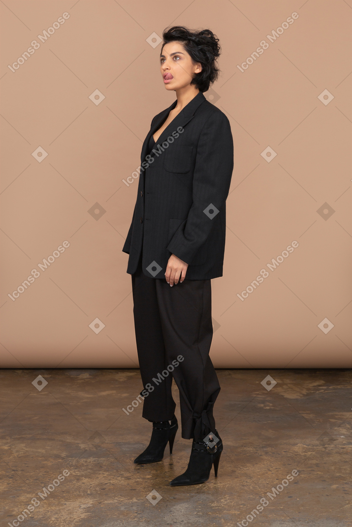 A woman in a black suit and high heels