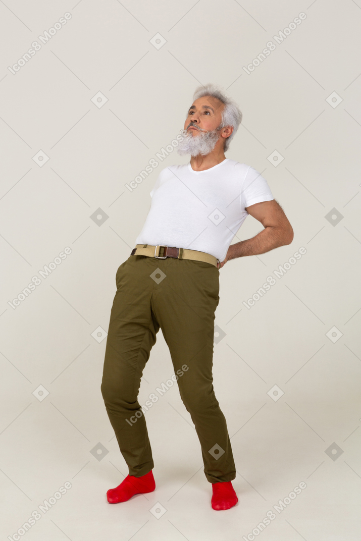 Man in casual clothes stretching his back