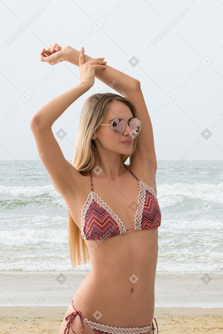 A woman in a striped bikini on the beach