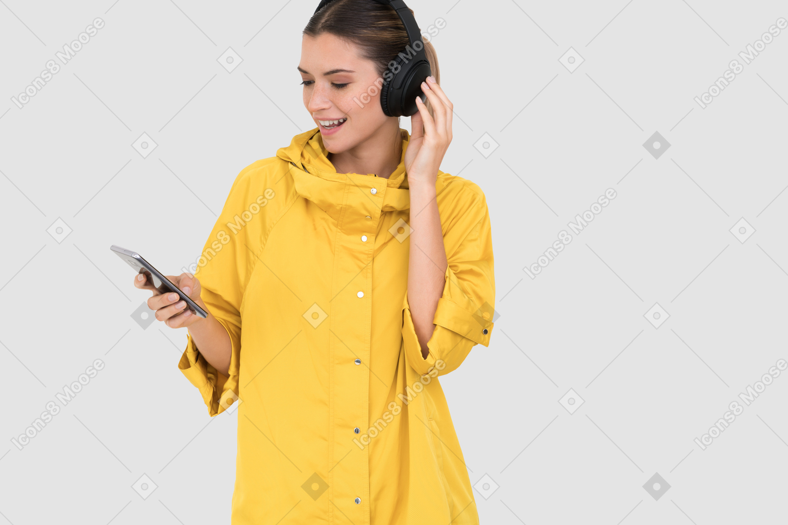 Woman in yellow raincoat listening to music