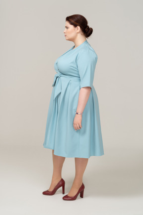 Side view of a woman in blue dress