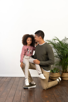 Young man on a knee with his daughter