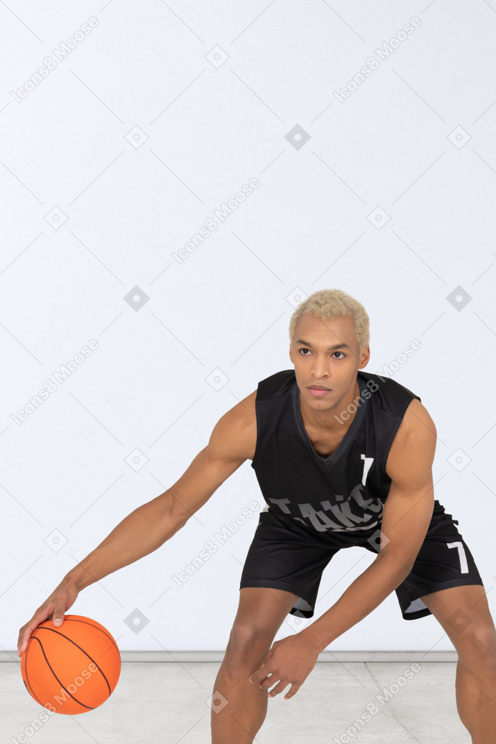 A man holding a basketball in his right hand