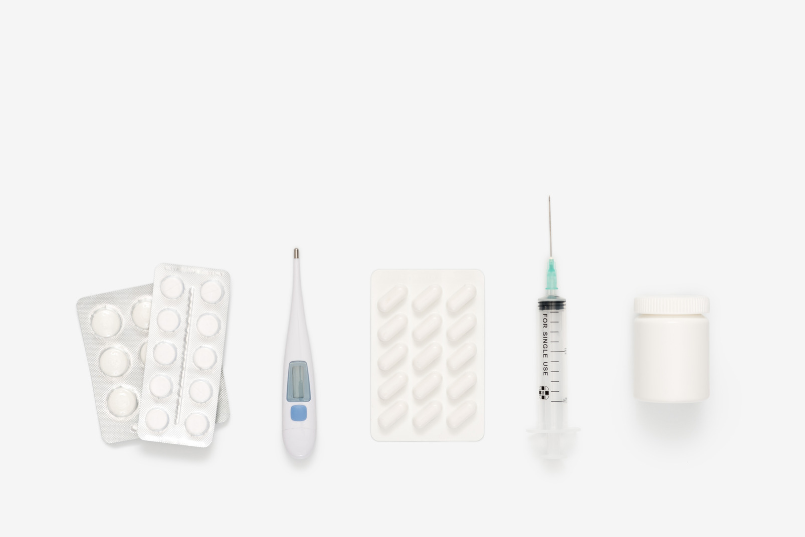 Medical syringe, digital thermometer and pills