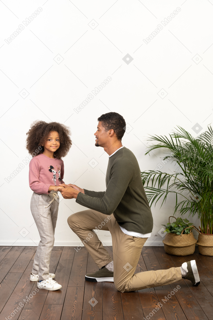 Young man on a knee with his daughter
