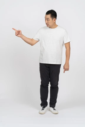 Front view of a man looking aside and making warning gesture