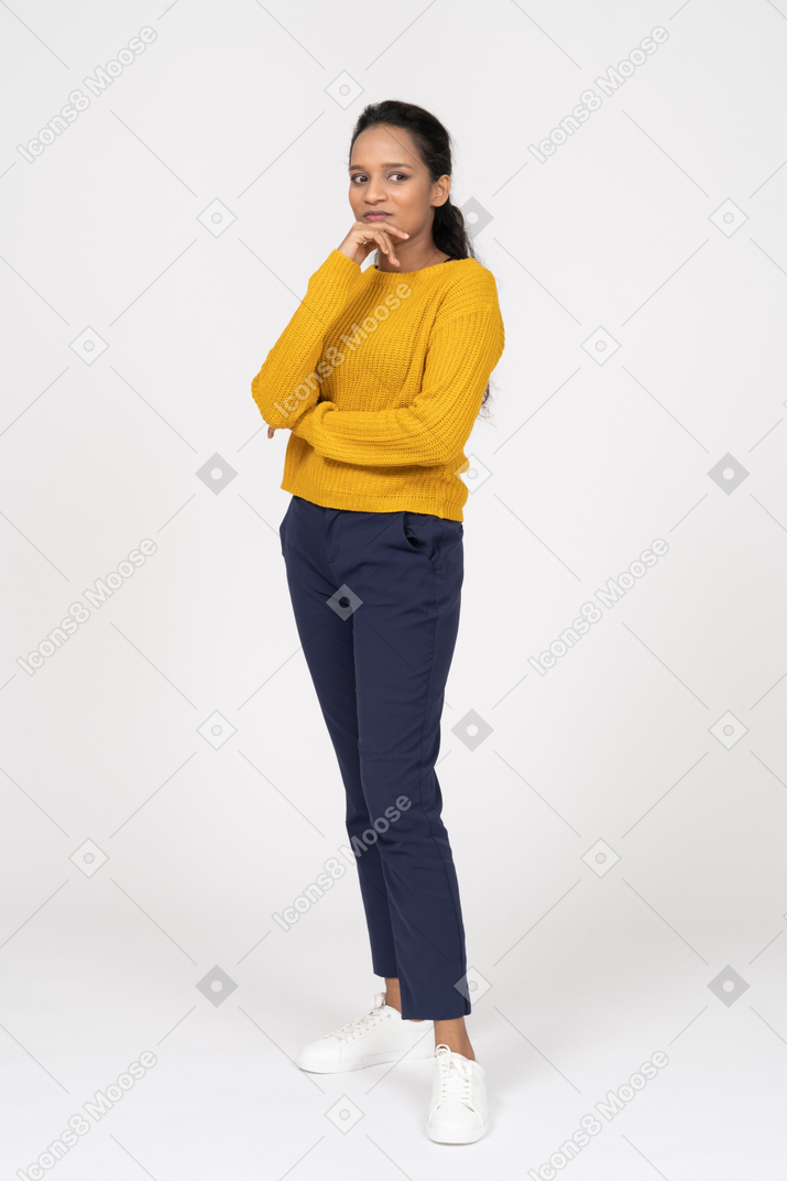 Front view of a thoughtful cute girl in casual clothes