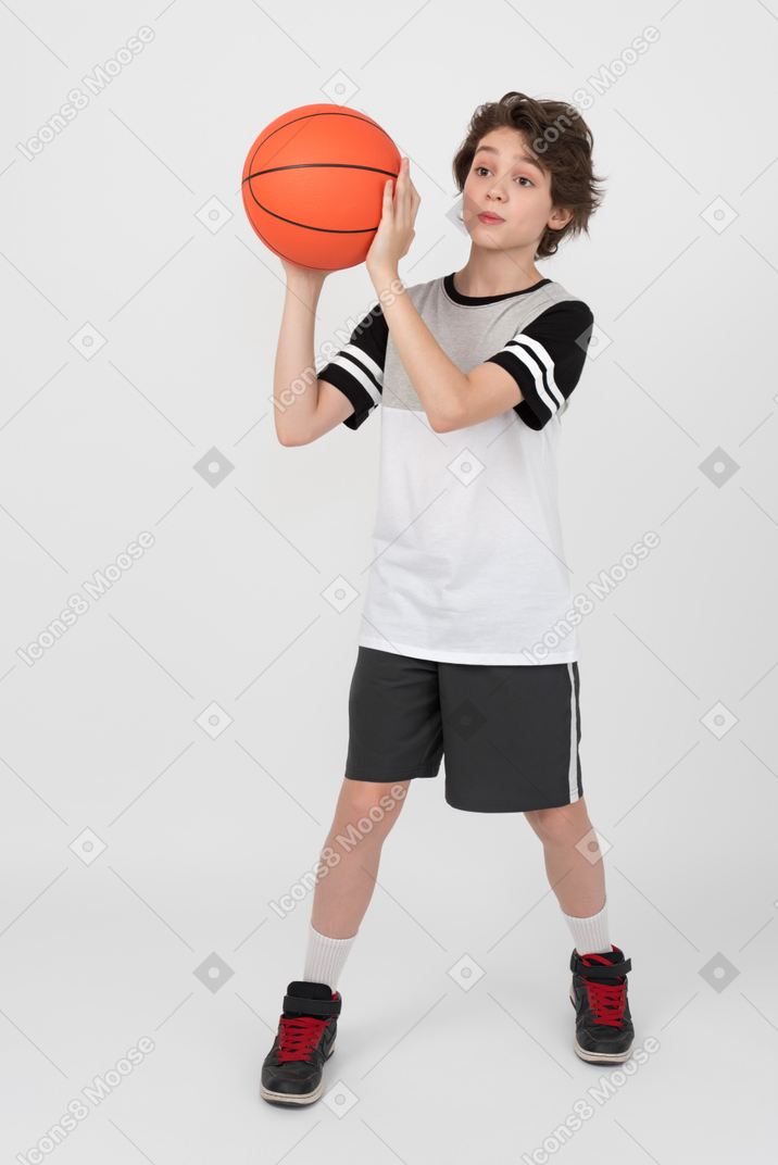 Boy with surprised face is going to throw a ball