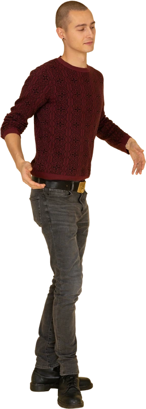 Three-quarter view of a gesticulating young man in red pullover