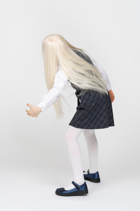 Back view of a schoolgirl leaning sideways