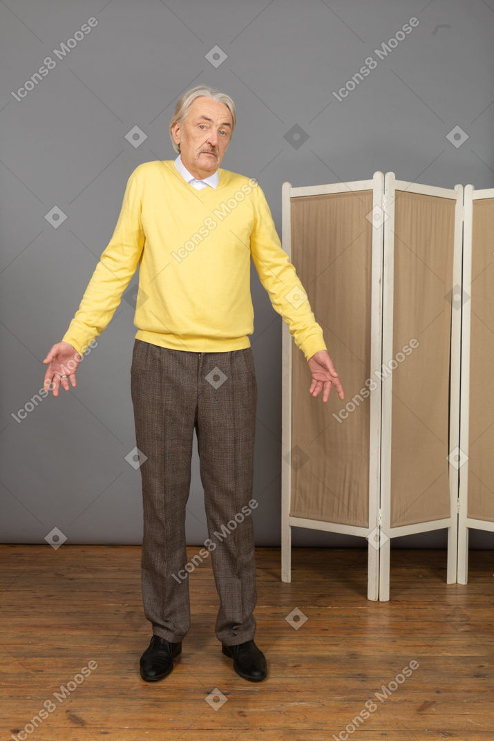 Front view of a questioning old man looking at camera