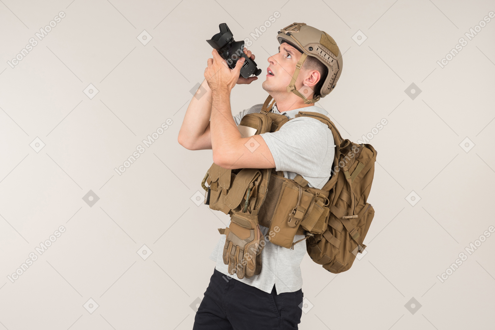 Male hot zone journalist in bulletproof best waiting for a shot