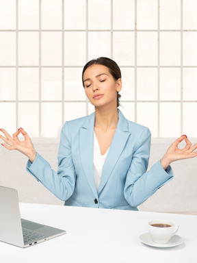 Business woman at laptop trying to calm down