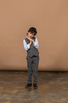 Front view of a cute boy in grey suit