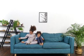 Good looking boy and girl play on the sofa