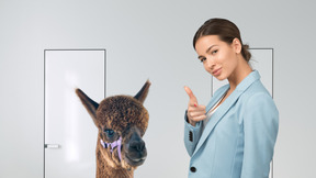 Woman pointing at something next to llama