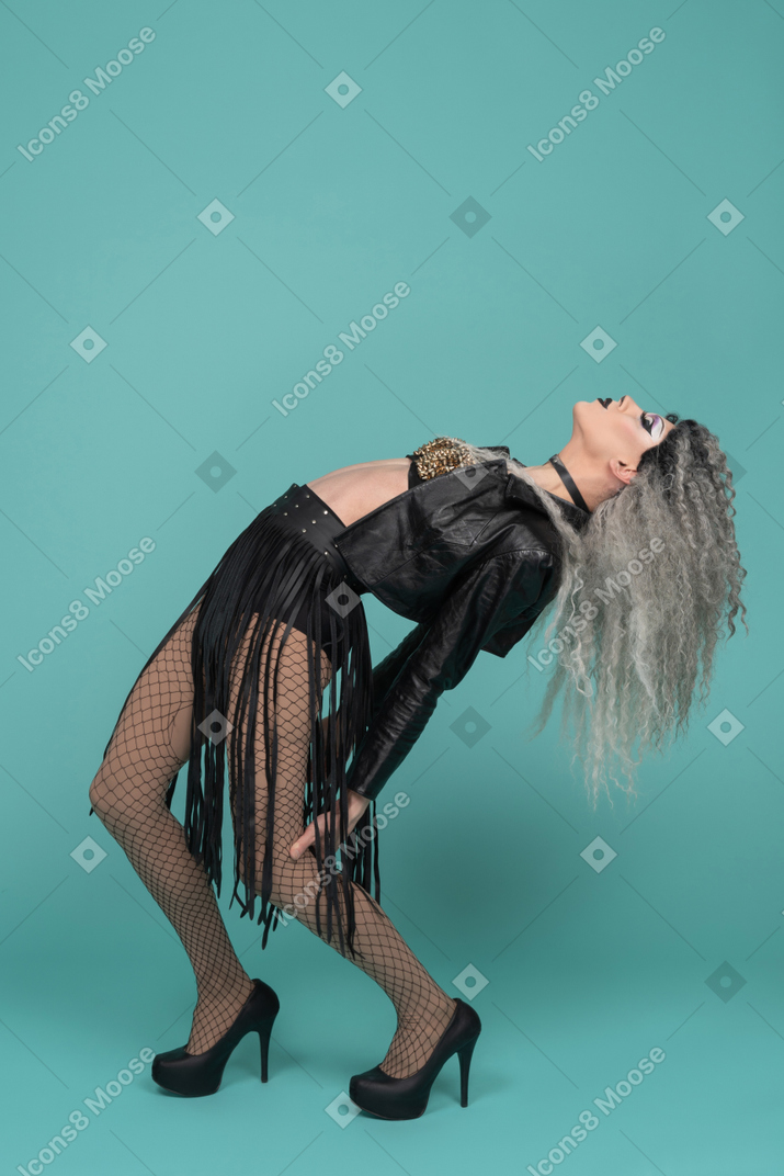 Drag queen in all black outfit leaning backwards and arching their back