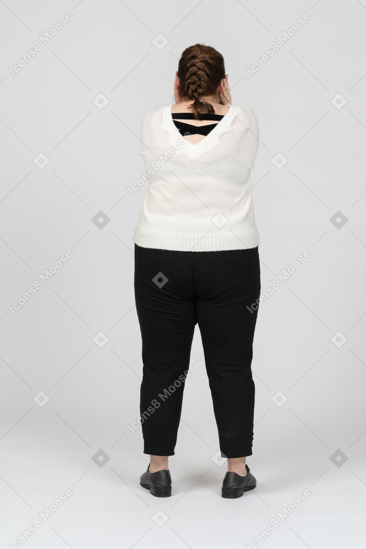Rear view of a plump woman in casual clothes