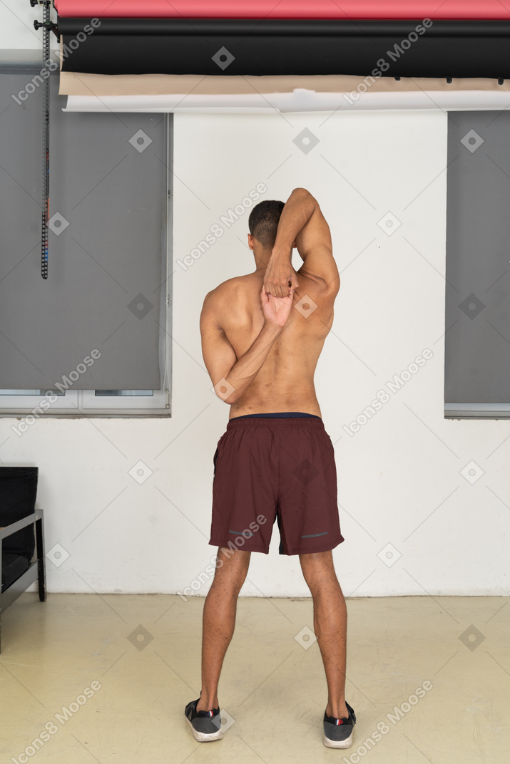 Back view of man doing stretching exercise
