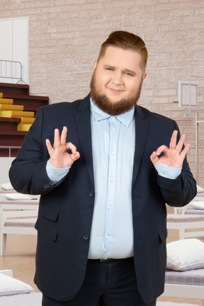 Man in a suit showing ok hand gesture