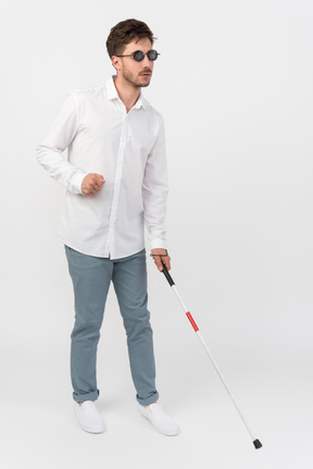 Blind man using a white cane