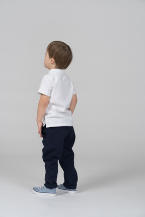 Back view of small boy looking up